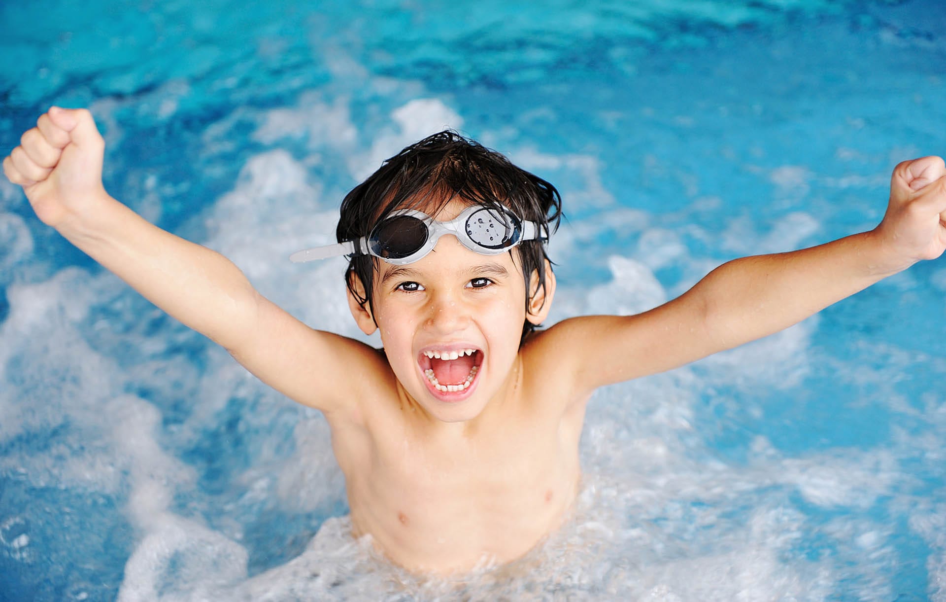 Happy child in swimming class