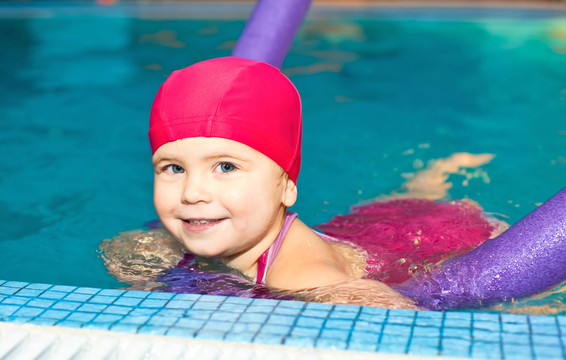 Girl floating on a swim noodle